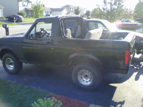 1994 Ford Bronco - Side view of a black 1994 Ford Bronco with its top removed.
