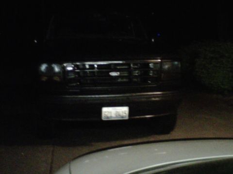 1994 Ford Bronco - Front view of a 1994 Ford Bronco, captured at night, showing its distinctive grille and headlights.