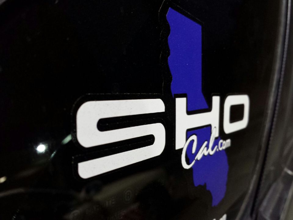 Black surface with white 'SHO' decal and blue California outline with 'Cal.com' text