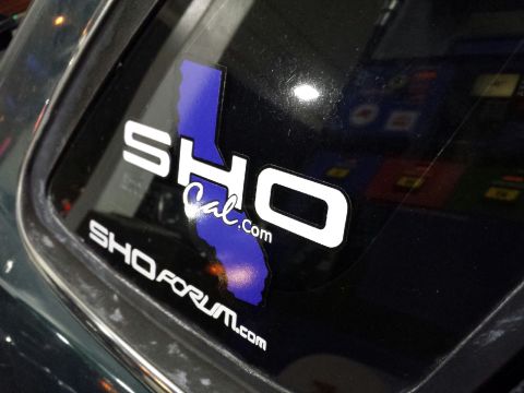 1993 Ford Taurus - Stickers on a car window, including one with California outline and SHO text.