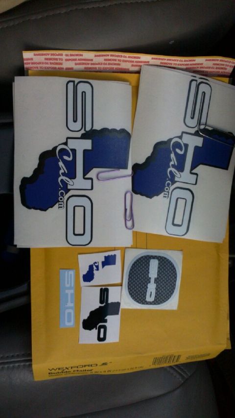 1993 Ford Taurus - Various decals, including SHO logos and a California outline, are displayed on a yellow envelope.