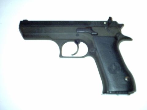 1995 Ford Bronco - A black handgun is shown in profile against a plain white backdrop.