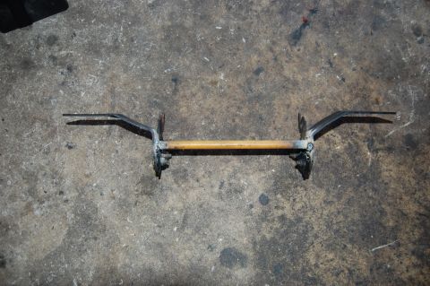 2006 Honda RANCHER - A metal bar with a wooden handle and two pointed prongs is shown on a concrete surface.