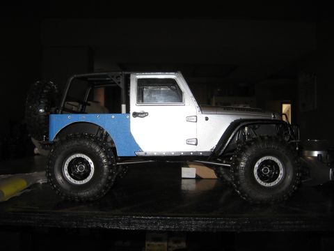 1993 Toyota 4Runner - This modified Jeep Wrangler features a custom blue bed and roll cage, with large off-road tires.