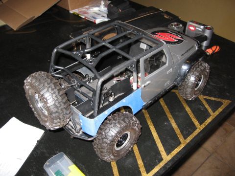 1993 Toyota 4Runner - A remote control rock crawler toy is displayed on a black surface with yellow markings.