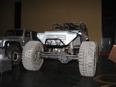 1993 Toyota 4Runner - Two remote control rock crawler vehicles are parked side-by-side indoors.