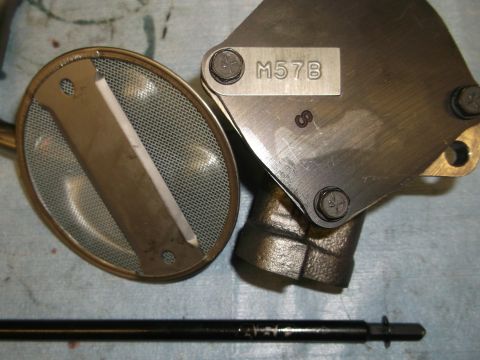 1967 Ford Mustang - Close-up of an oil pump assembly, a mesh screen and stamped part number M57B.