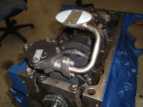 1967 Ford Mustang - Close-up view of an engine's oil pan and pickup tube assembly.