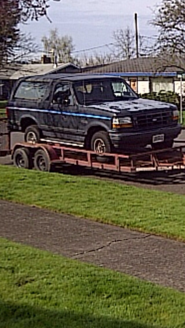 Dark blue 1992 Ford Bronco on a trailer, 3/4 front view