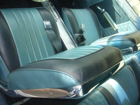 1965 Pontiac Catalina - The interior features two-tone teal and black upholstery with chrome accents and seatbelts.
