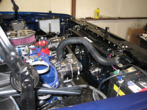 1982 Ford Bronco - The engine bay of a vehicle is shown with various components and wiring visible.