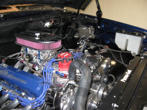1982 Ford Bronco - Close-up view of a modified engine bay with chrome accents and blue spark plug wires.