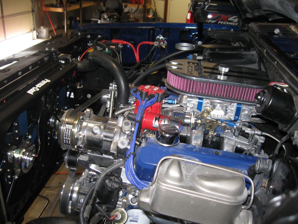 Engine bay with supercharger, chrome air cleaner, and blue valve covers