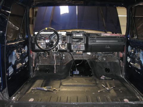 1982 Ford Bronco - The interior of a vehicle is shown with the dashboard and steering wheel exposed, indicating disassembly.