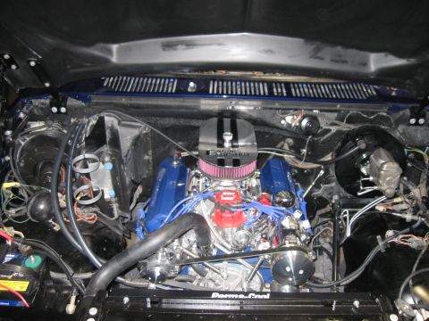 1982 Ford Bronco - The engine bay of a vehicle, showing the motor and associated components.