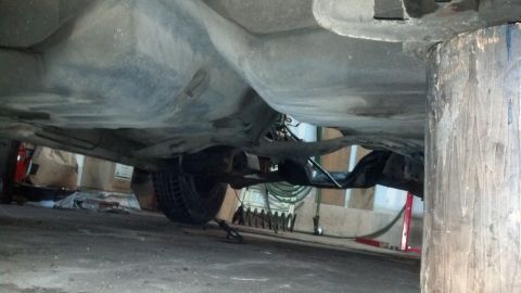 1985 Mercury Grand Marquis - Underside view of a car, focusing on the fuel tank and rear suspension assembly.