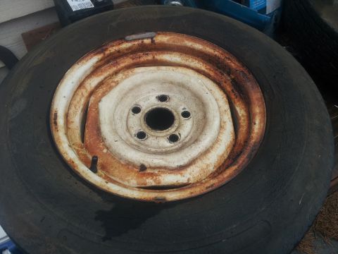 1986 Ford Bronco - Spare tire and rim, condition is heavily rusted.