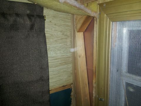 1986 Ford Bronco - Interior view showing wood paneling, a dark curtain, and a window frame, likely from a camper or RV.