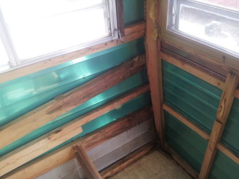 1986 Ford Bronco - The interior framing shows exposed wood beams and green paneling, with windows visible.
