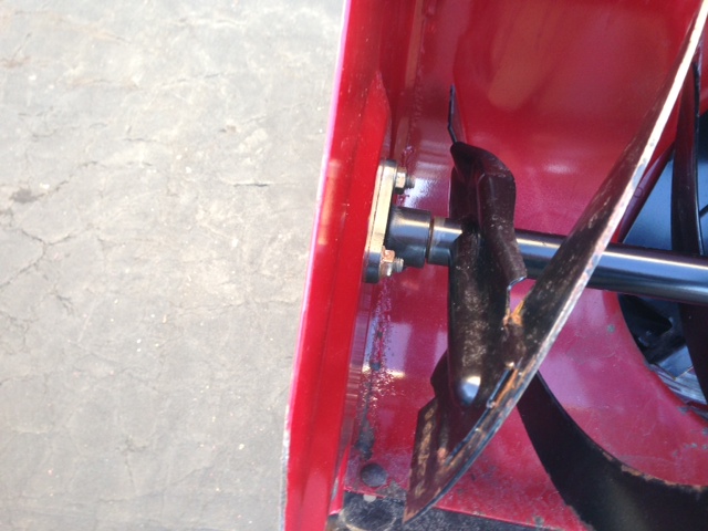 Red snow blower auger mechanism with metal blades