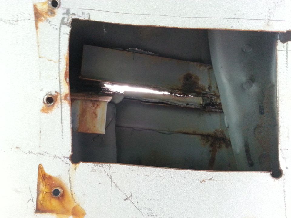 shot from the inside of the sail panel, I was able to easily knock out the old reinforcement panels..you can already see the day light coming through.