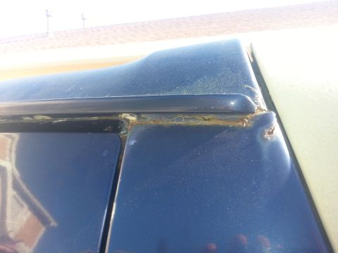 1994 Ford Bronco - Rust is visible on the upper body panel of a blue vehicle, indicating potential structural issues.