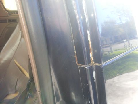 1994 Ford Bronco - Rust is visible along the door frame of this vehicle, indicating potential body damage.