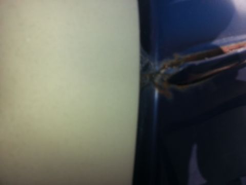 1994 Ford Bronco - Rust is visible on the seam of a blue vehicle door.