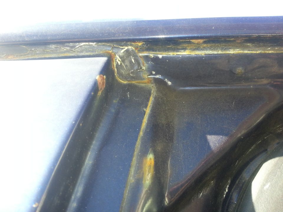 Close-up of rusted door frame and surrounding metal
