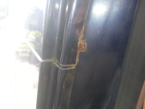 1994 Ford Bronco - Rust is visible along the door frame of the vehicle, indicating potential damage.