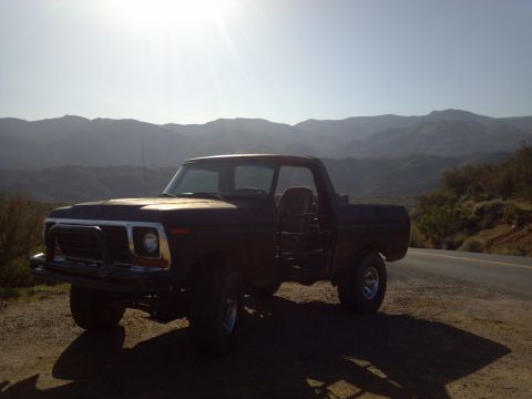 1978 Ford Bronco - This 1977 Ford F-150 pickup truck is parked on a dirt road overlooking a mountain range.