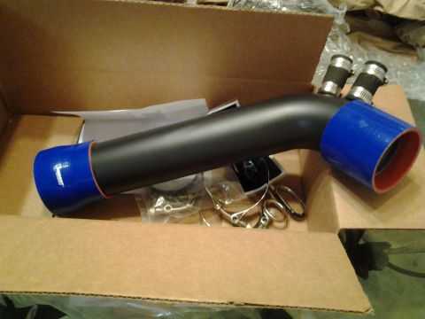 2004 Ford Crown Victoria - A black intake pipe with blue silicone couplers and hose clamps is shown in a cardboard box.