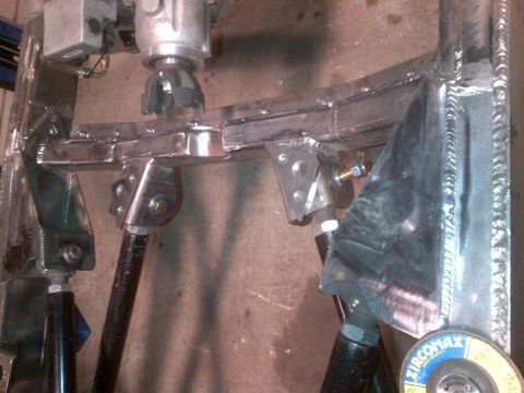 1985 Jeep CJ7 - Close-up of custom-fabricated suspension components, showing welding and metalwork.