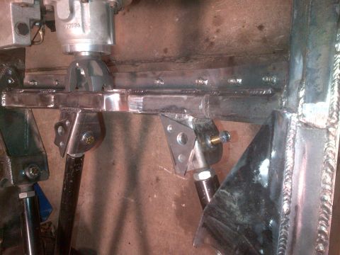 1985 Jeep CJ7 - Custom suspension components are visible, showing welds and bolted connections.