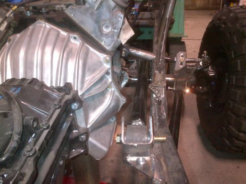 1985 Jeep CJ7 - Close-up view of engine and suspension components, likely during a custom build or repair.