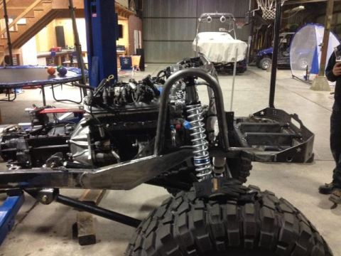 1985 Jeep CJ7 - This Jeep CJ7 chassis is undergoing modification in a workshop with other vehicles visible.