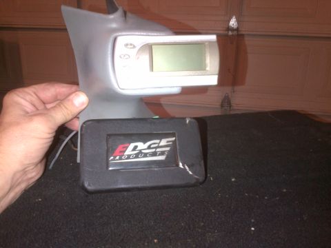 1985 Jeep CJ7 - A hand holds an Edge Products performance tuner with a digital display and control buttons.