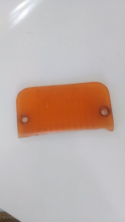 1995 Ford Bronco - This is an orange plastic part with two screw holes, likely a lens or cover.