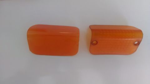 1995 Ford Bronco - Two orange plastic vehicle marker light lenses are shown against a plain background.