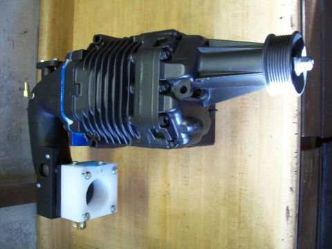 2001 Ford Ranger - Supercharger assembly mounted on a wooden surface.