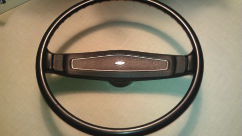 1980 Pontiac Trans Am - A close-up view of a vehicle's steering wheel, showing its central emblem.