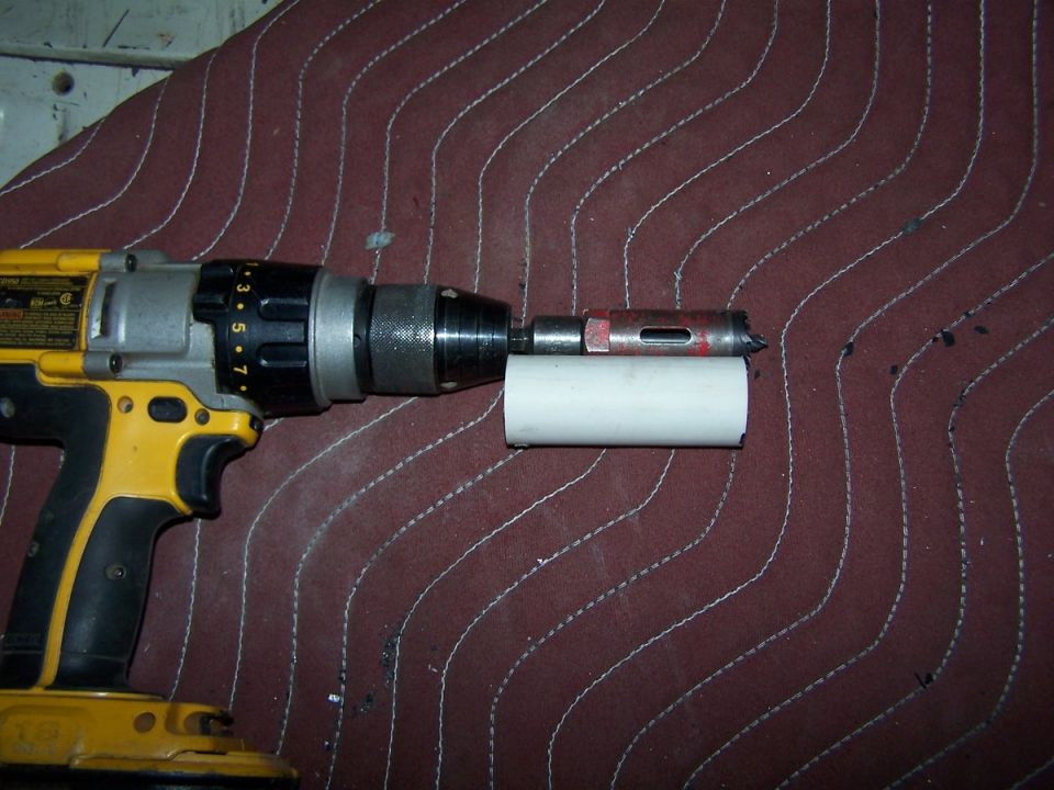 A hunk of PVC cut to length for a cheap stop for the hole saw to drill out the corners.