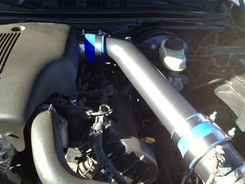 1998 Ford Crown Victoria - Custom intake pipes are installed in the engine bay, connecting various components.