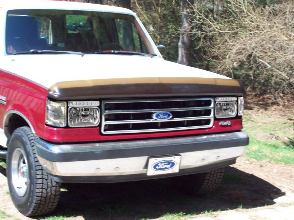 Front of a red and white 1987-91 Ford 4x4 with clear headlights and clear corner markers