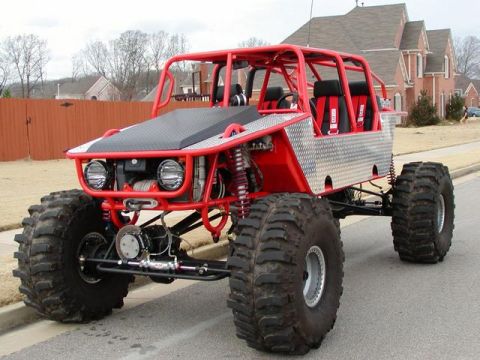 1988 Ford Bronco - This custom-built buggy features a prominent red roll cage and oversized tires for off-road use.