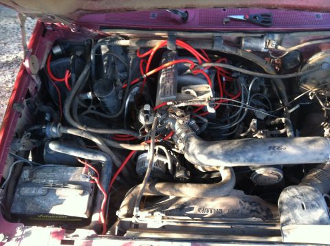 1994 Ford Bronco - The engine bay of a 1994 Ford Bronco, red spark plug wires and a K&N air intake.