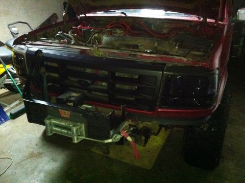 1994 Ford Bronco - Front view of a 1992 Ford Bronco with its hood up, an installed winch.