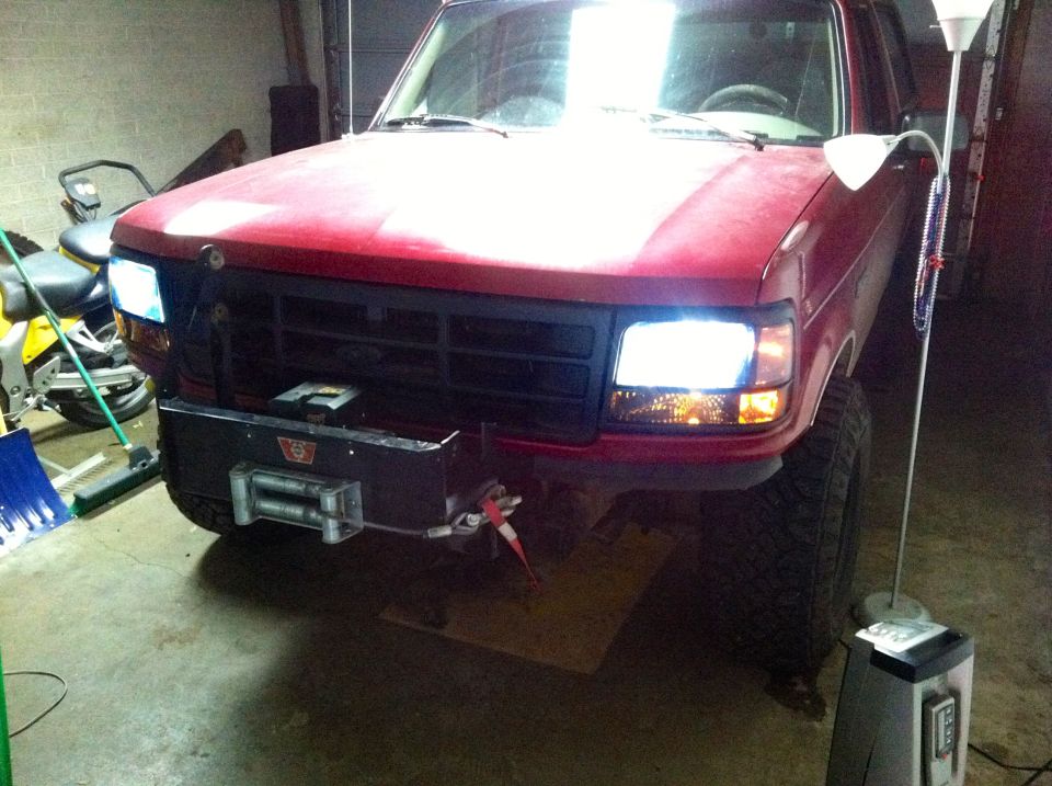 Front view of a red 1994 Ford Bronco with a winch mounted on the bumper