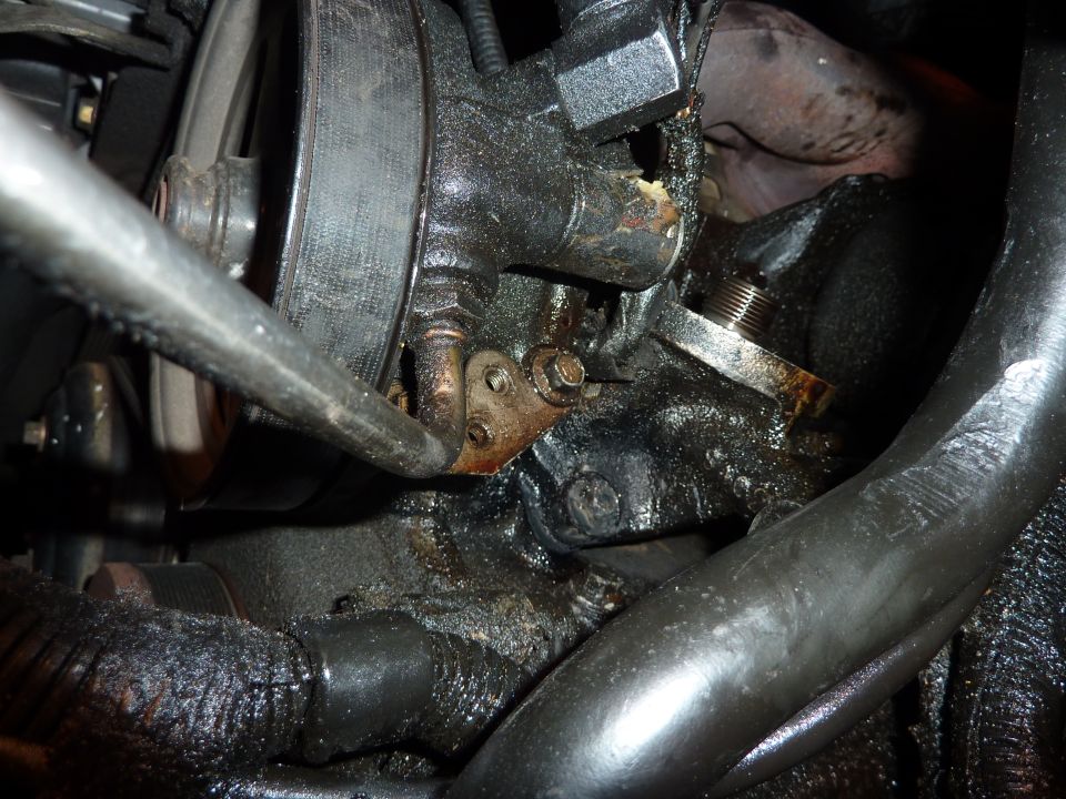 Engine part with oil leaks and a pulley