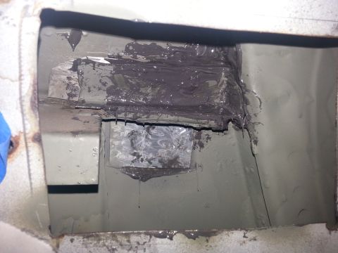 1992 Ford Bronco - This is a close-up view of a section of a vehicle's underbody that has undergone repair work, with sealant applied.